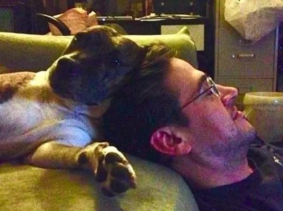 Jake relaxing with a dog on couch
